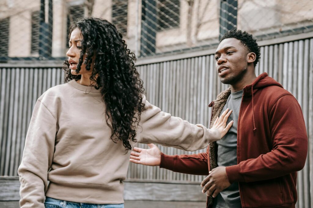 Couple arguing in street.